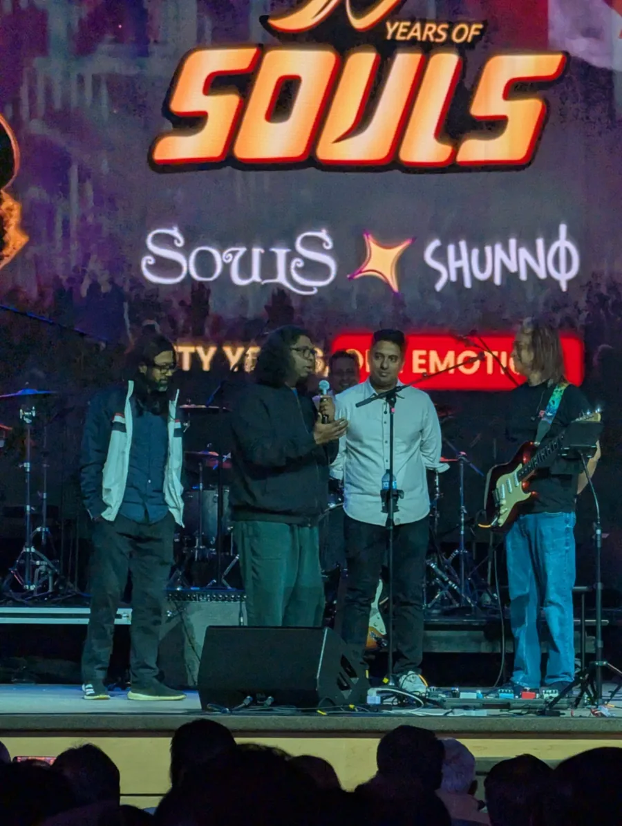 Mehmood Afridi Tony, Lincoln D'Costa, Imrul Karim Emil and Partho Barua on stage under the 50 Years of Souls screen